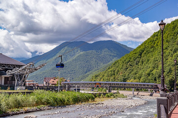 View of the mountains, overgrown with dense deciduous and coniferous forests, beautiful at any time of the year, with modern transport and economic communications for the active recreation of people