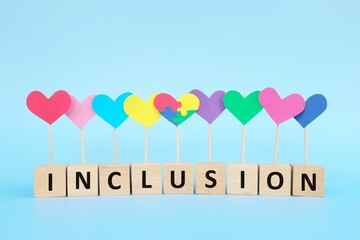 Concept of child with autism spectrum disorder equality, diversity and inclusion in society. Puzzle heart shape among multicolored group.