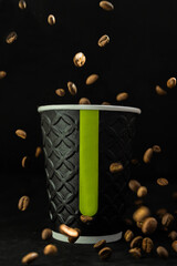 coffee beans fall into a cup of coffee