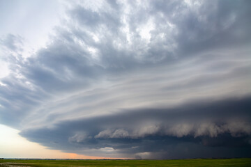 Naklejka na ściany i meble Supercell thunderstorm with ominous storm clouds and severe weather