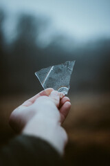 hand holding paper plane