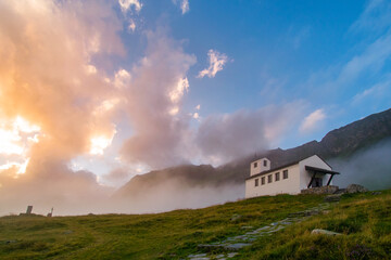 amazing clouds during sunset in the mountains and a church (Montafon, Vorarlberg, Austria)