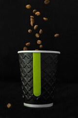 coffee beans fall into a cup of coffee