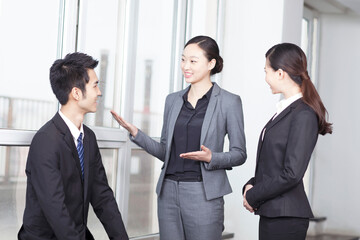 Group of coworkers in discussion in office foyer