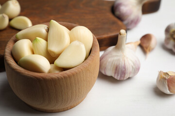 Fototapeta na wymiar Fresh organic garlic on white table, closeup