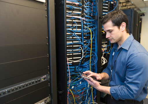Technician inspecting network server