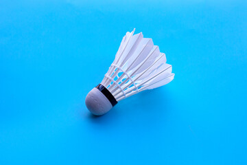 Fototapeta na wymiar Shuttlecock or badminton ball on blue background.