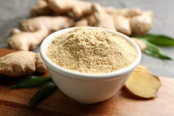 Dry and fresh ginger on wooden board, closeup