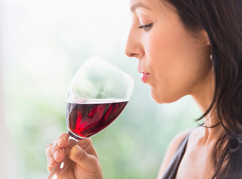 Woman tasting red wine