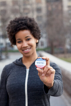Portrait of woman with vote pin