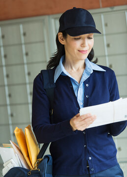 Female postal worker holding letter