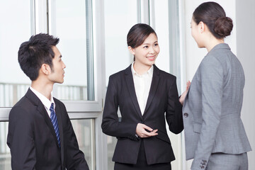 Group of coworkers in discussion in office foyer