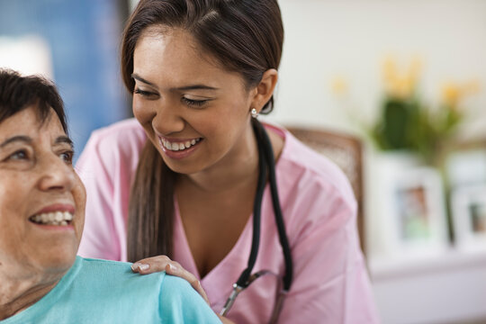 Young female nurse attending patient