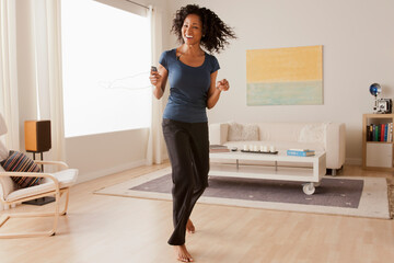 Mid adult woman dancing at home