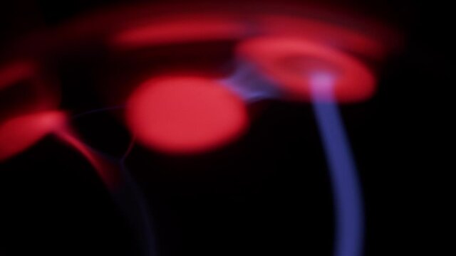 Plasma Filaments And Red Light Dancing Against Glass