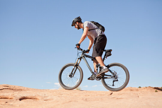 USA, Utah, Moab, Mid adult man riding mountain bicycle in remote scenery