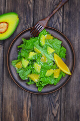 fresh summer homemade salad of vegetables and fruits, orange, lettuce, avocado and sesame seeds, healthy food, organic, vegetarian eco health and immunity products