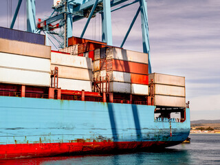 Container ship in hte habour loading and unloading containers