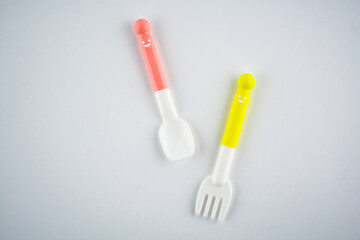 Colorful eating utensils for baby on white background