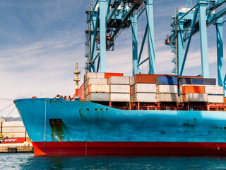 Container ship in hte habour loading and unloading containers