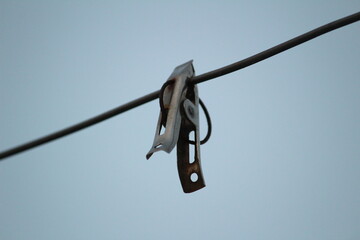 group of color and stainless steel clips hang on the rope without clothes