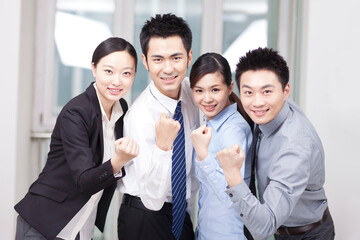 Group of happy young business people cheering 