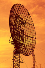 Close-up military radar. Radar on the background of the sunset orange sky - 405301606