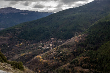 Spruce forest and village in the highlands (Greece, Peloponnese) on a winter day