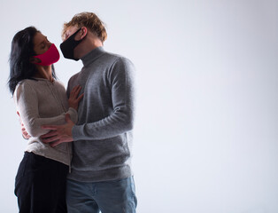 Portrait of young attractive family couple with surgical medical mask standing together
