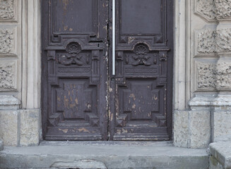 Fototapeta premium Old vintage brown door. Abstract exterior and interior around the entrance. Doors of city houses.