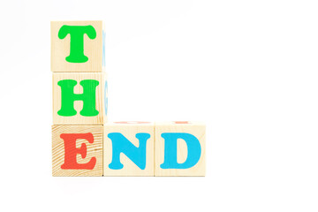 word the end made of colored cubes on white background