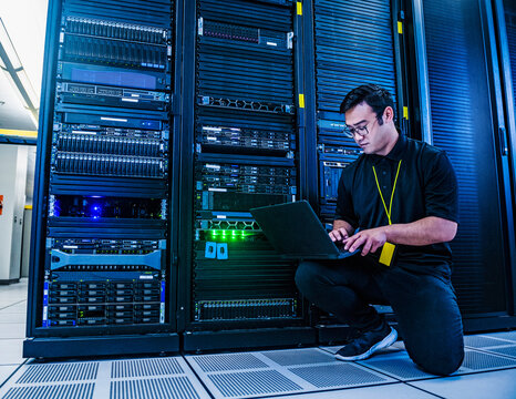 Employee working on server rack in data center