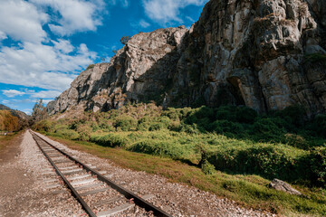 Fototapeta na wymiar Old Railway with rocky mountains and stone walls on a sunny day in Suesca, Cundinamarca - Colombia