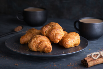 A cup of coffee with croissants for breakfast. The concept of Breakfast.