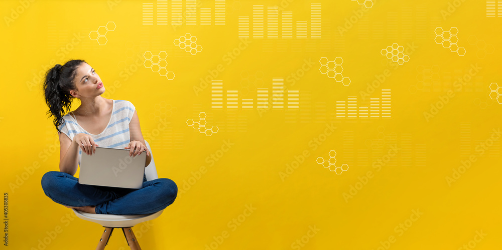 Aufkleber digital graphs and hexagon grids with young woman using a laptop computer