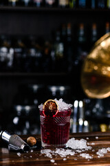 Red cocktail with raspberries and orange, Red cocktail with ice at bar