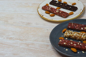 set of oatmeal, buckwheat and rice cereal bars on wooden table, protein sports food for weight control