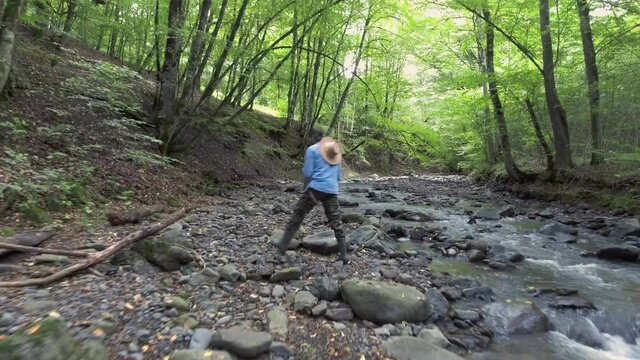 Fisherman are fishing in a mountain stream for brook trout. Fly Over River and Fishing Man. Trout fly fishing and catching. Fish Catch cinematic top view footage. High view.