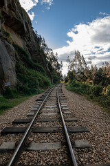 Fototapeta premium Old Railway with rocky mountains and stone walls on a sunny day in Suesca, Cundinamarca - Colombia