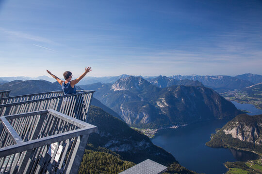 Stunning view from the top of Krippenstein mountain, the Five fingers observation platform with view of the Salzkammergut region.  Woman enjoying stunning view.