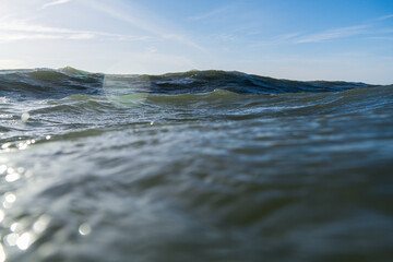 Breaking Waves and spray, white water and light reflected on the surface of the water