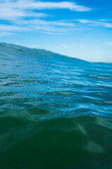 Breaking Waves and spray, white water and light reflected on the surface of the water