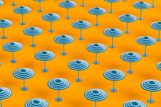 Full frame shot of beach umbrellas on orange background
