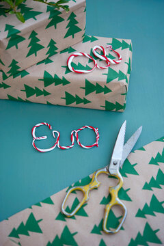 Old scissors, wrapped Christmas presents and names made of polymer clay