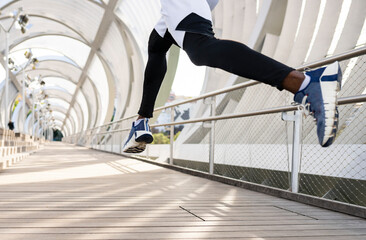 Athlete wearing sports shoe running on walkway