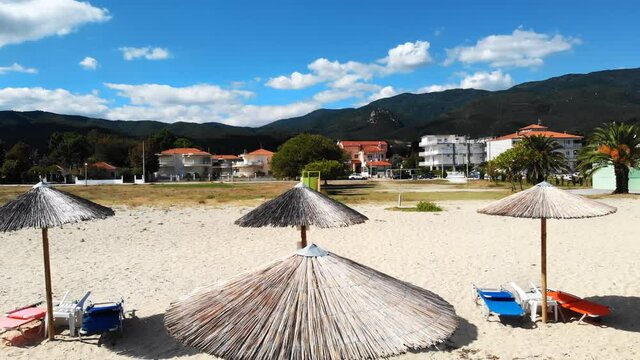 Beach with umbrellas and sunbeds. Foam. Top drone view