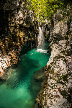 Turquoise river and waterfall