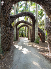 Artistic abstract arches made out of twigs in a tropical botanical garden