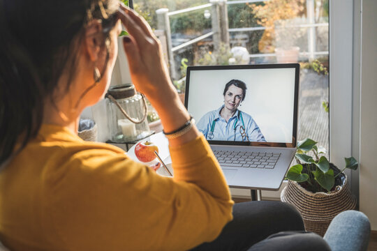 Female Doctor Smiling On Laptop Screen During Video Call