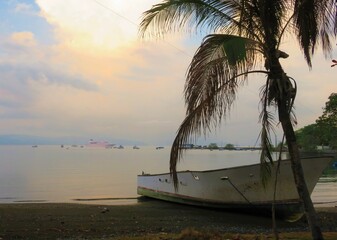sunset on the beach with a boat in Central America
